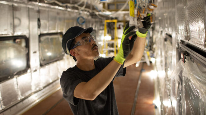 worker at Siemens Mobility NC manufacturing rail hub