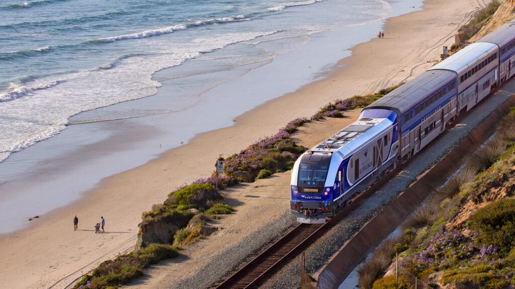 Amtrak’s Pacific Surfliner train on the rails next to the shore