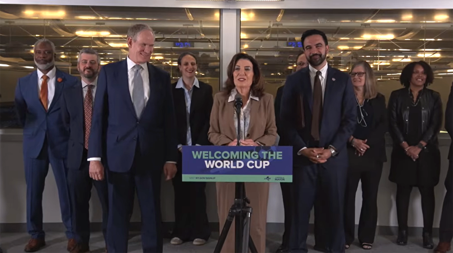 New York Governor Kathy Hochul, New York City Mayor Zohran Mamdani, and Metropolitan Transportation Authority CEO Janno Lieber with others at a news conference
