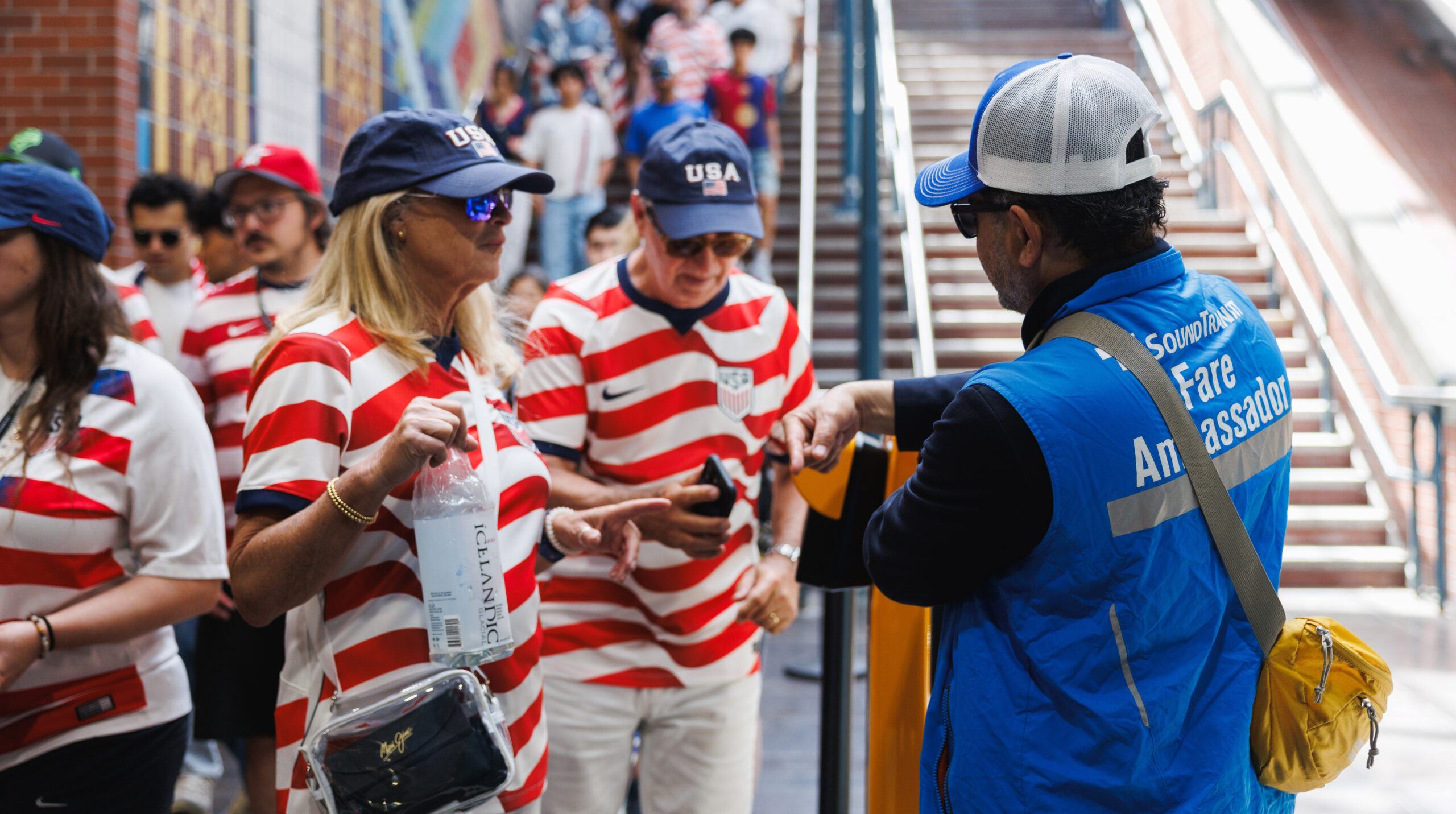 A fare ambassador assists two fans at Pioneer Square Station after Seattle's second world cup game between the USA and Australia on June 19, 2026. Photo: Sound Transit