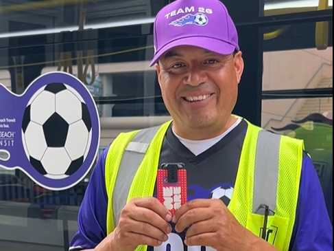 An LBT employee holding a FIFA badge.