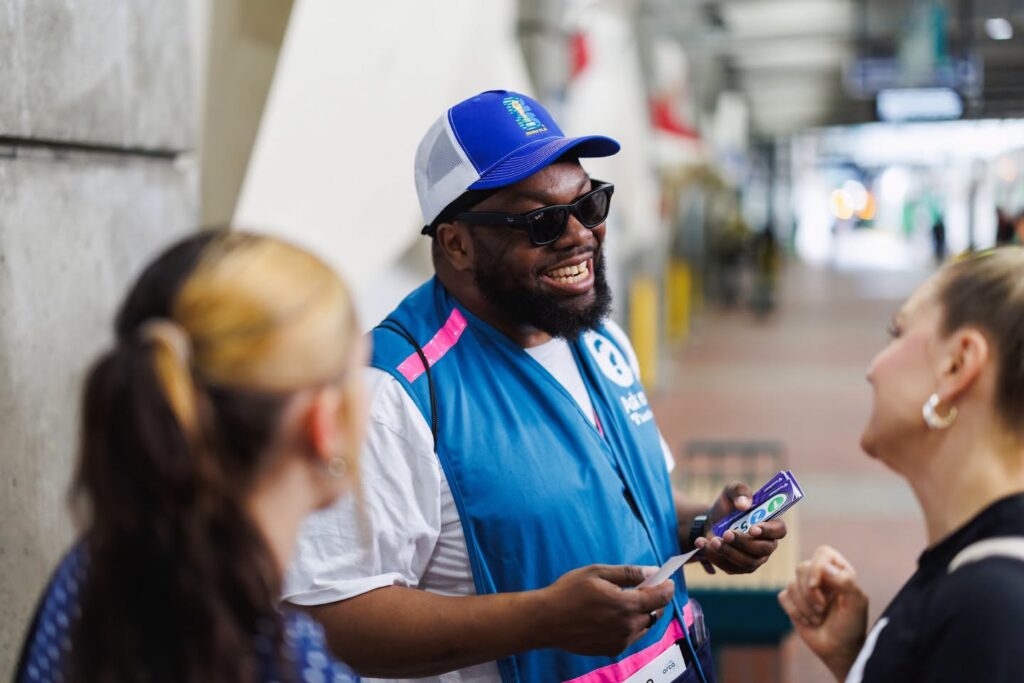 Sound Transit employee helps two women during the World Cup.