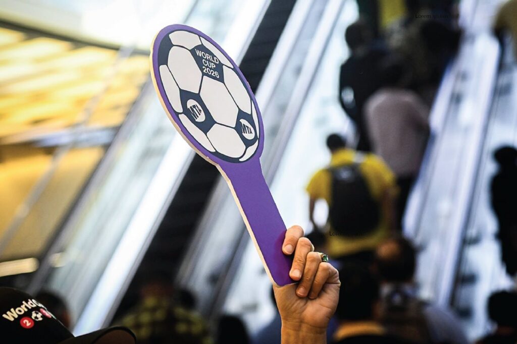 MTA soccer ball sign held by a transit ambassador.