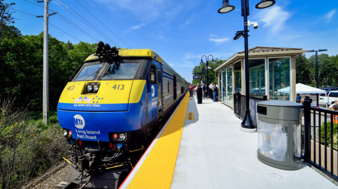 NYMTA LIRR train at a station.