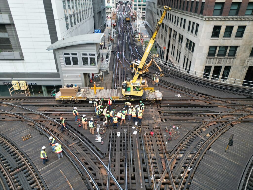 Overhead view of a construction work site on railroad tracks.