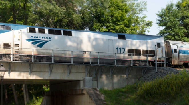 Amtrak train going over a bridge.