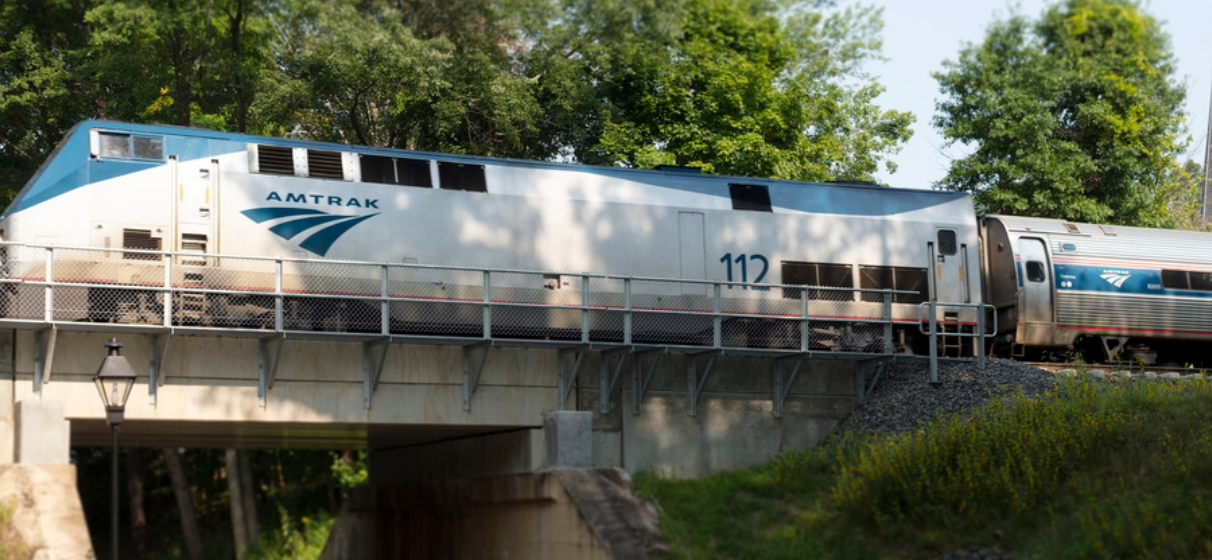 Amtrak train going over a bridge.