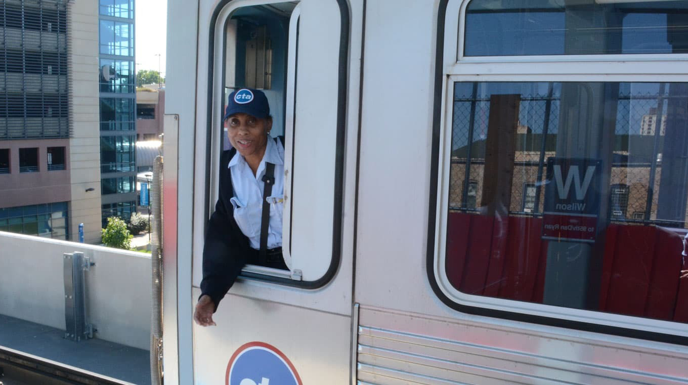 CTA train with an operator looking out the window.