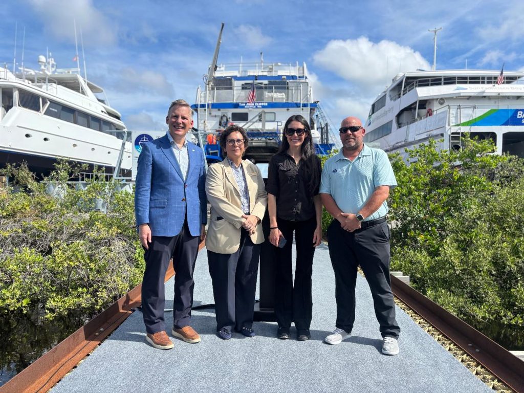 U.S. Rep. Anna Paulina Luna poses with PSTA leaders and others in front of three boats.
