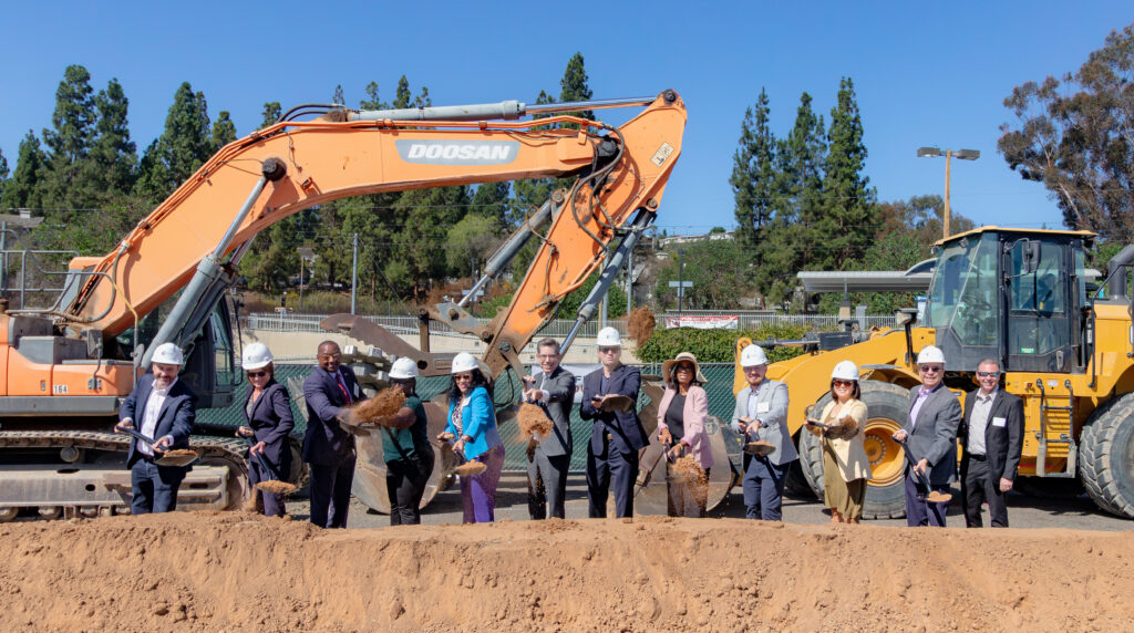 MTS leadership and others with shovels and hardhats at a groundbreaking.
