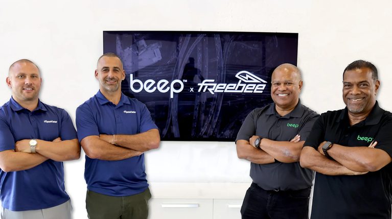Four men from Beep and Freebee pose